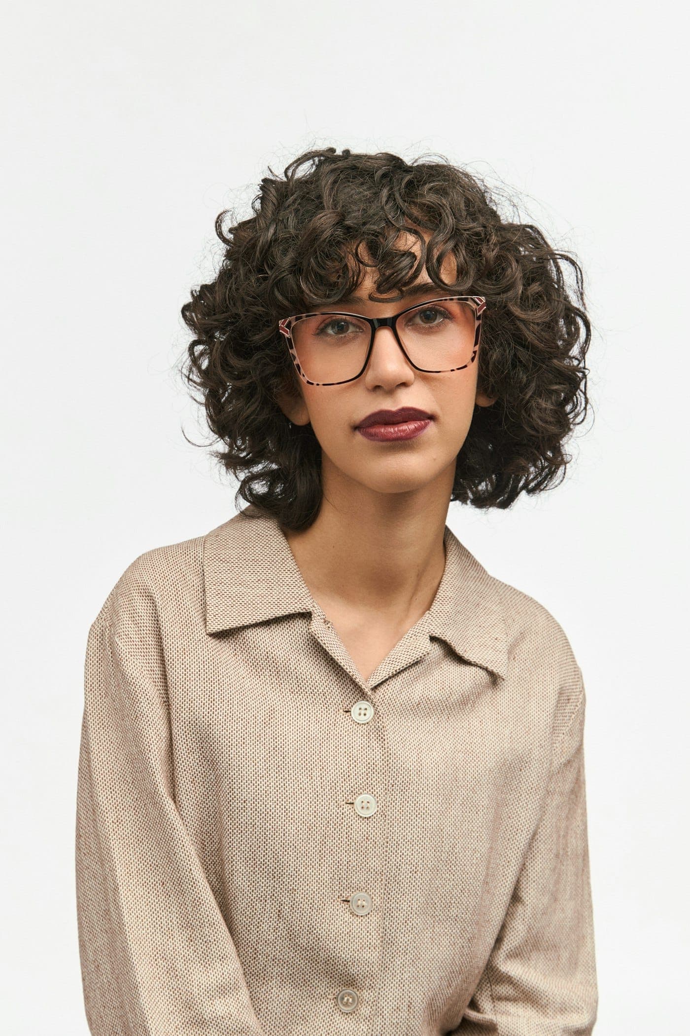Frontal portrait of a woman in cat-eye optical frames, used for the fit analysis preview